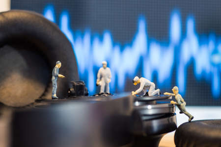 Miniature people : Close up engineer checks the sound quality of the headphoneの写真素材