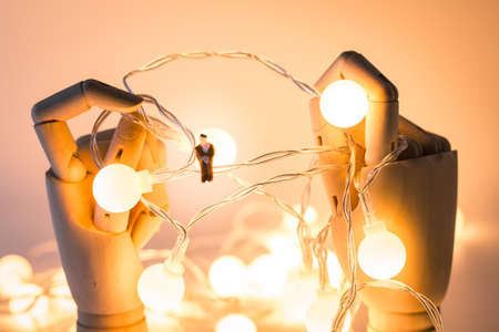 Miniature people, Close up young man sitting on electric wire