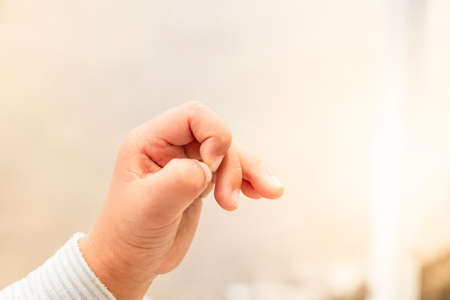baby's hand in white bright background with copy space textの写真素材