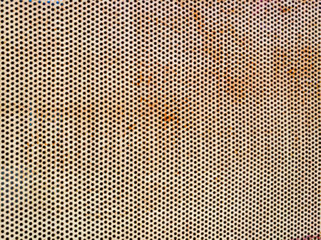 rust surface on circle pattern metal plate, pattern of circle hole on rust metal plateの写真素材