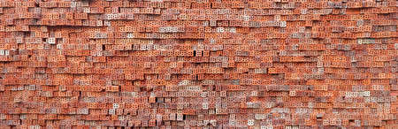 red brick wall pattern for blank background, red-brown bricks pile is waiting for constructionの写真素材