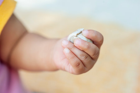 selective focus of baby hand with copy space text, babies learn to use their handsの写真素材