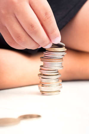 selective focus of children's hand arrange coins vertically, concept of finance with children