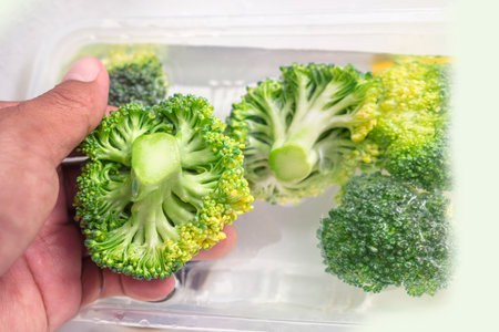 broccoli was held in hand while washing with copy space textの写真素材