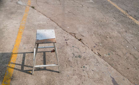 old hand-made chairs on a concrete floor with copy space textの写真素材