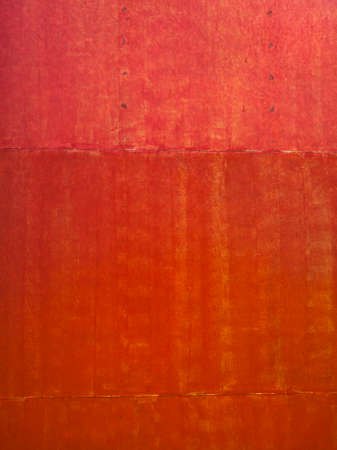 old red metal sheet surface with painting brush pattern, red metal sheet abstract backgroundの写真素材