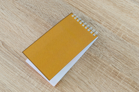 Note book on wood backgroundの写真素材