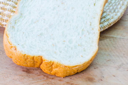 whole weat bread slices on wood background