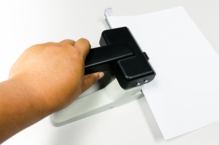 Hands pressing drill paper  on worker tableの写真素材