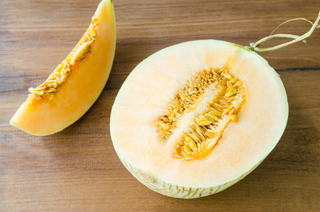 Fresh sliced cantaloupe on wooden backgroundの写真素材