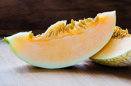 Fresh sliced cantaloupe on wooden backgroundの写真素材
