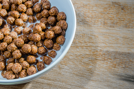 Bowl of cereal on wood backgroun.