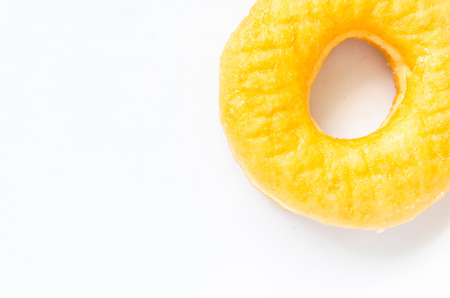 Close up yellow donut isolated on white backgroundの写真素材
