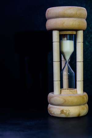 Closeup hourglass on black background