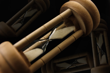 Hourglass on black background. Concept deadline time.