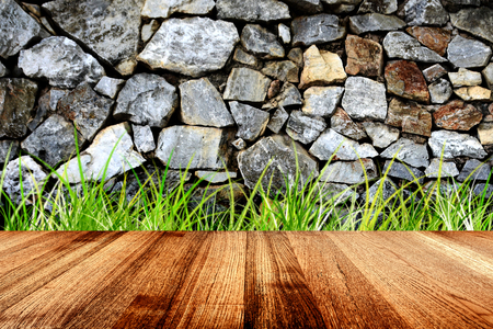 Wood planks and green grass on abstract stone background, Brown natural wood texture. Empty wood for display or montage your productsの写真素材