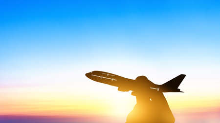 Silhouette of young asian holding miniature toy airplane flying on cloud blue sky at sunset background. Travel and trip at summer by airplane with copy space