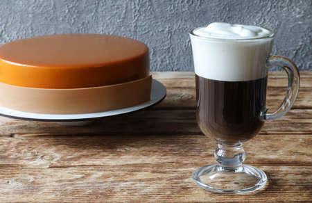 Mousse cake with a glass of Irish coffee on the tableの写真素材