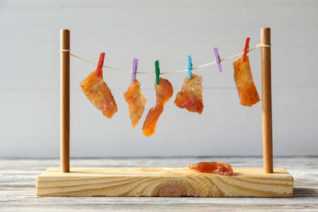 Jerky meat is dried on a ropeの写真素材