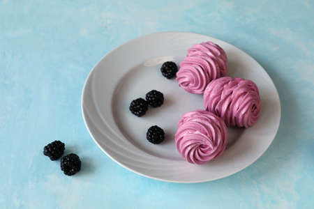 Delicious and fresh zephyr with blackberries on a plateの写真素材