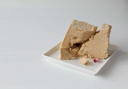 An unusually shaped halva on a white plateの写真素材