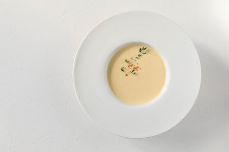 Traditional Italian egg soup ginestrata with spices - nutmeg, thyme, and cinnamon from Tuscany - top view with copy spaceの写真素材