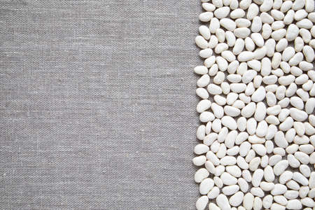 Big white beans from Peru - a culinary background concept for healthy eating and vegetarian - top view of Lima beans and linen canvas with copy spaceの写真素材