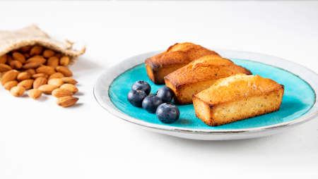 Traditional French pastries for Christmas - financier cake with blueberry on a beautiful plate with...