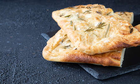 Italian bread - traditional two pieces of focaccia. Focaccia consists of flour, olive oil, water,...