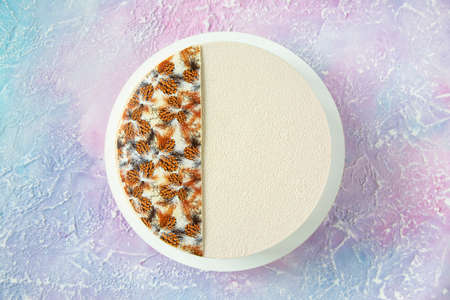 Winter Christmas cake in white with decor on top and copy space - a beautiful view from above on the table with a dessert of white chocolate and velor with frosty streaksの写真素材
