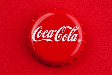 Muenster, Germany - September 10, 2011: Picture shows coca cola bottle cap on red background.のeditorial素材