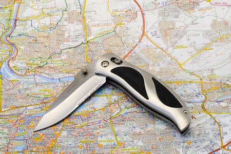 a knife lying on a map - close upの写真素材