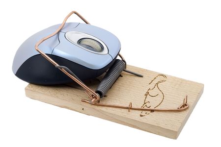 a computer mouse caught in a mousetrapの写真素材