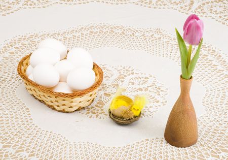 a basket of eggs, easter chicken and a pink tulipの写真素材