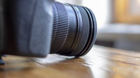 Camera with lens close-up. SIDE VIEW. Selective focus