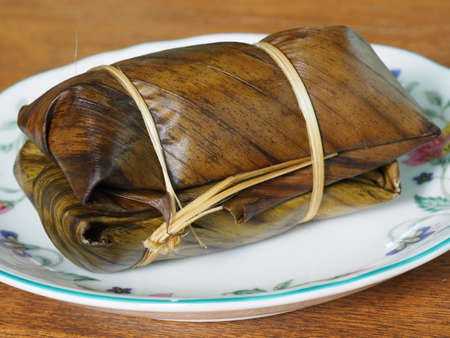 Bananas in Steamed Sticky Rice Covered With Banana Leaf, Traditional Thai Dessert Sweet Food, Called Khao Tom Mad Or Khao Tom Padの写真素材