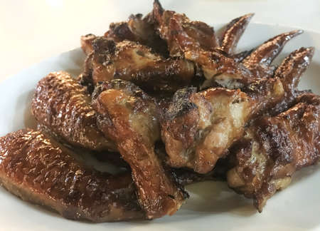 Grilled BBQ Chicken Wings On White Plateの写真素材