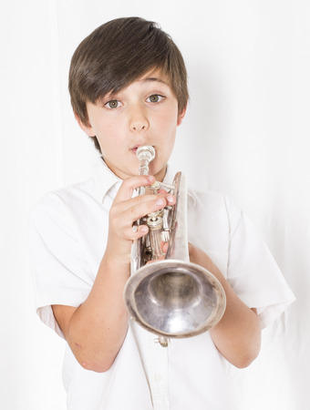 portrait of a boy playing the trumpetの写真素材