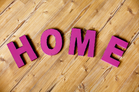 purple letters "home" on woodの写真素材
