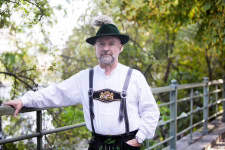 portrait of a bavarian man with a hat outdoorsの写真素材