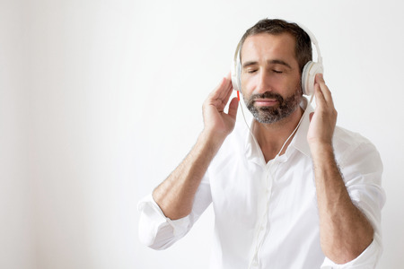 man in a white shirt and headphones