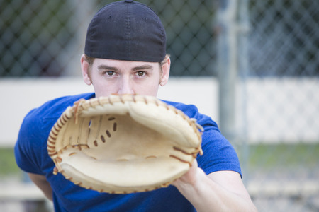 young man with baseball glove on a sports field