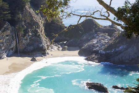 beautiful McWay falls in Big Sur California with sandy beach and blue waterの写真素材