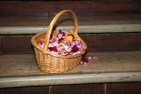 basket full of petals sitting on stairsの写真素材