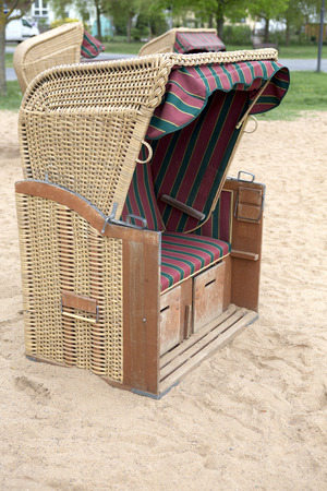 hooded german beach chair standing in the sandの写真素材