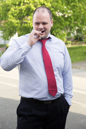 man in shirt and tie smoking a cigarの写真素材