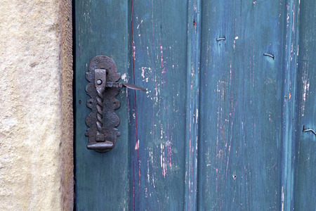 old blue wooden entrance door with antique door handle