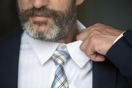 closeup of businessman loosens his shirtの写真素材