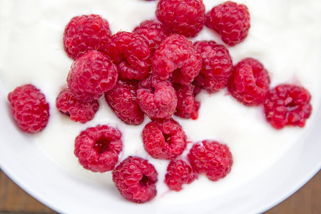 bowl of raspberries with yogurtの写真素材