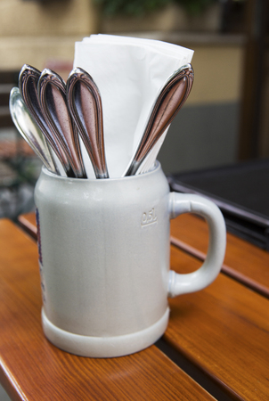 beer mug with silverware on a tableの写真素材